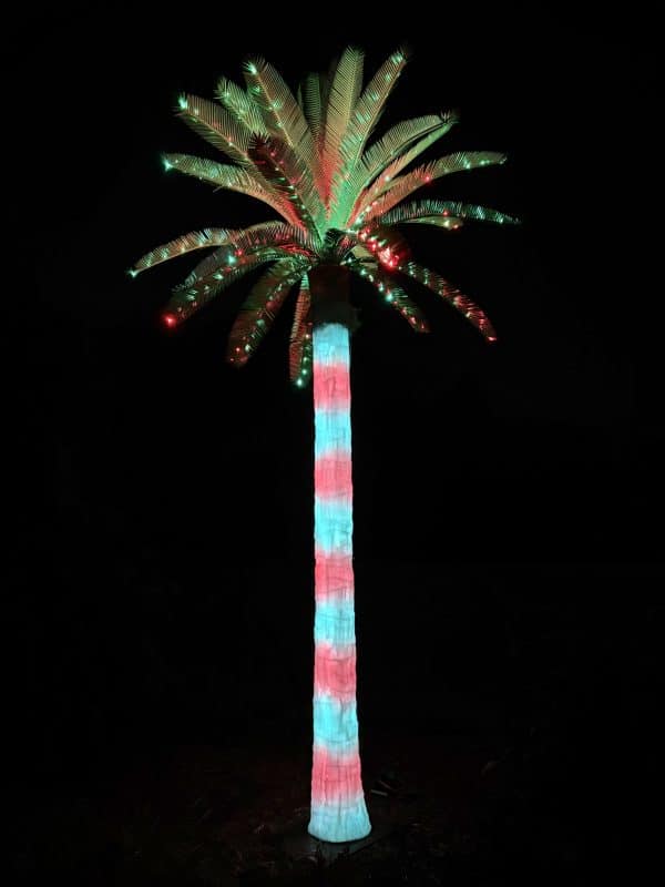 lighted-outdoor-artificial-palm-tree-christmas-red-green-glowing Glowing red and green Christmas lighted outdoor artificial palm tree at dusk